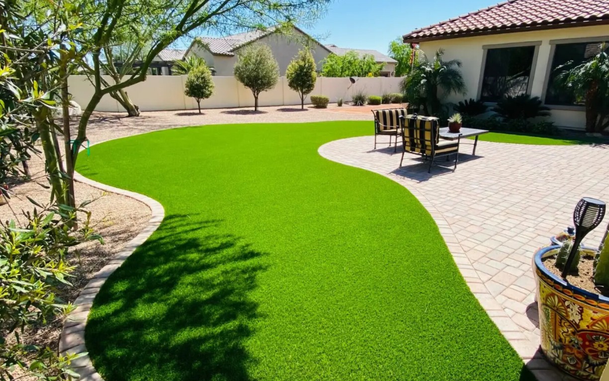 Beautiful residential backyard with artificial grass installation in Montgomery, AL